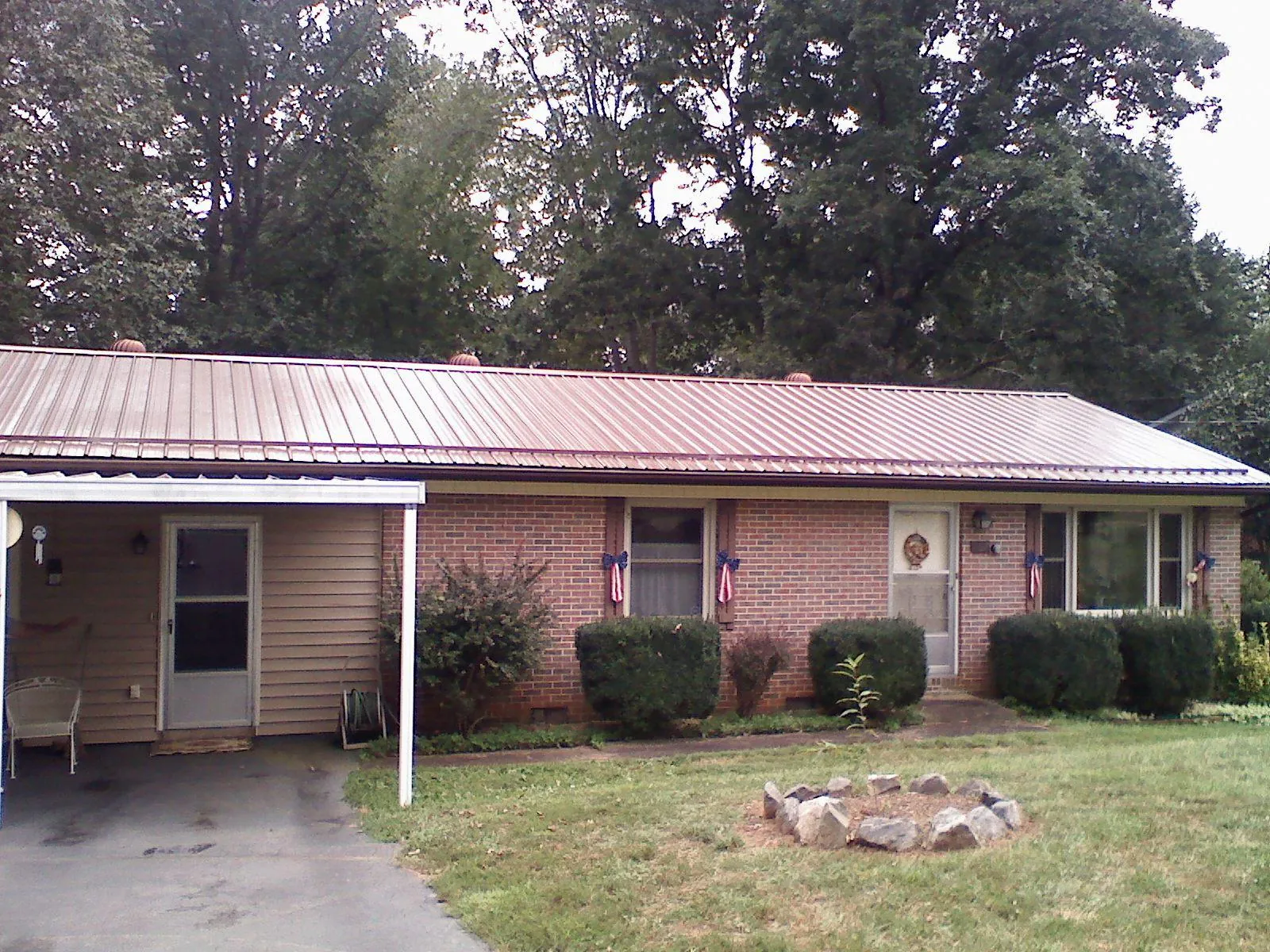 Bronze metal roof and carport on a brick ranch home — Roof Repair work by our crew in Elizabethtown